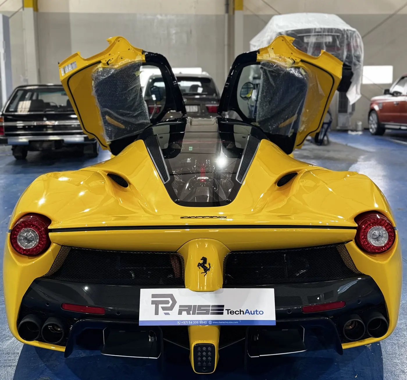 Car Detailing Dubai 47 Yellow Ferrari with doors raised during detailing at Rise Tech Auto Dubai