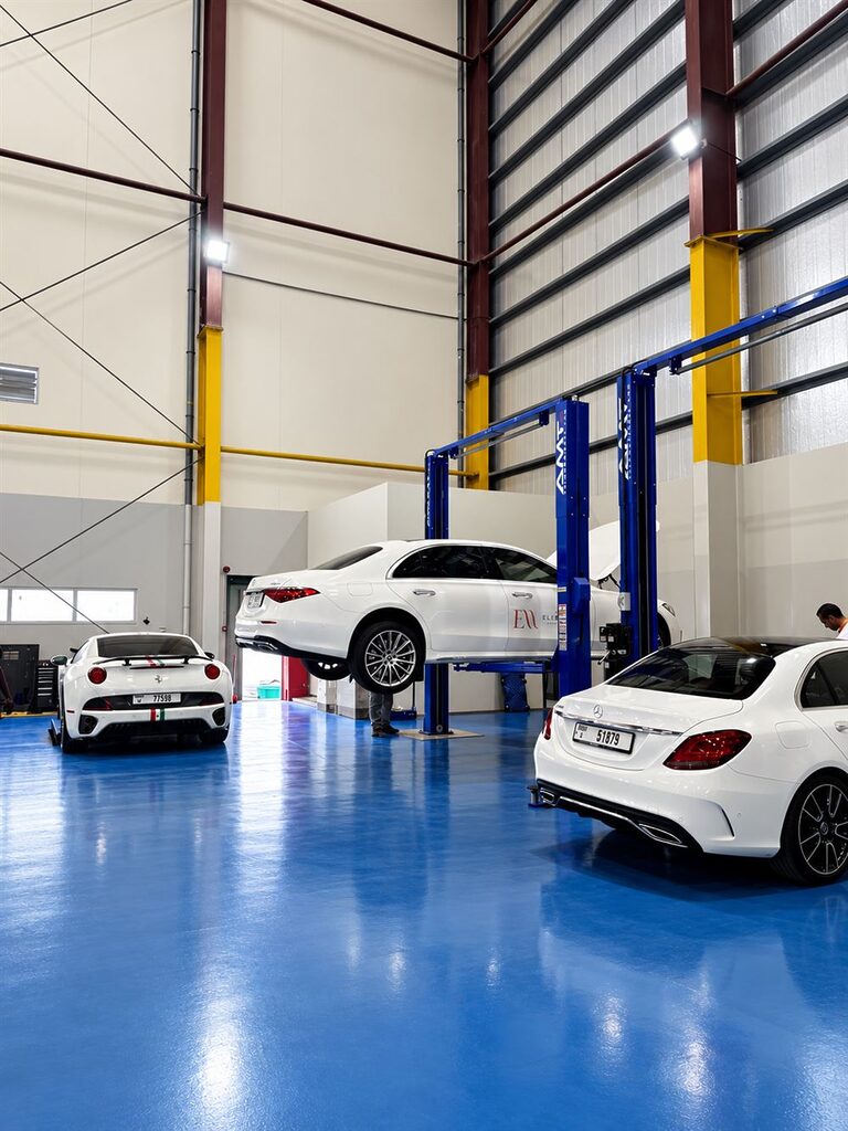 Rise Tech Auto workshop interior with car lifts and luxury cars in Dubai Investment Park